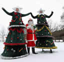 Illuminated Stilt Christmas Trees with Santa